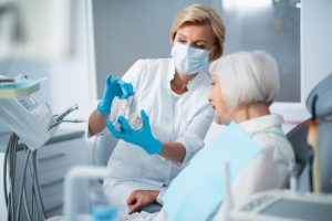 Woman,Sitting,In,Dental,Chair,With,Her,Dentist,In,The