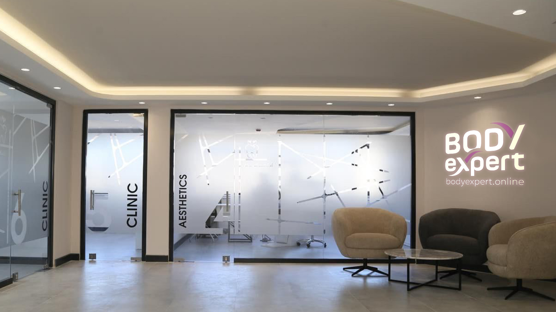 Glass-fronted reception area of a Body Expert centre, with doors marked Clinic and Aesthetics and a seating area